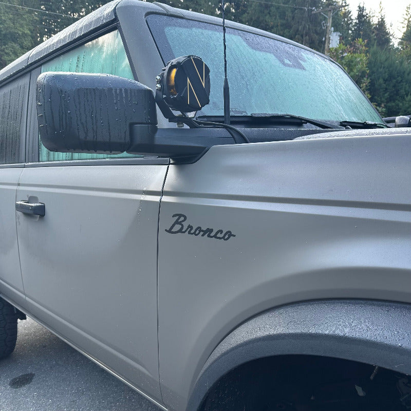 overall view of a satin Ford bronco badge decal applied on a fender of a matte march grey bronco 2025